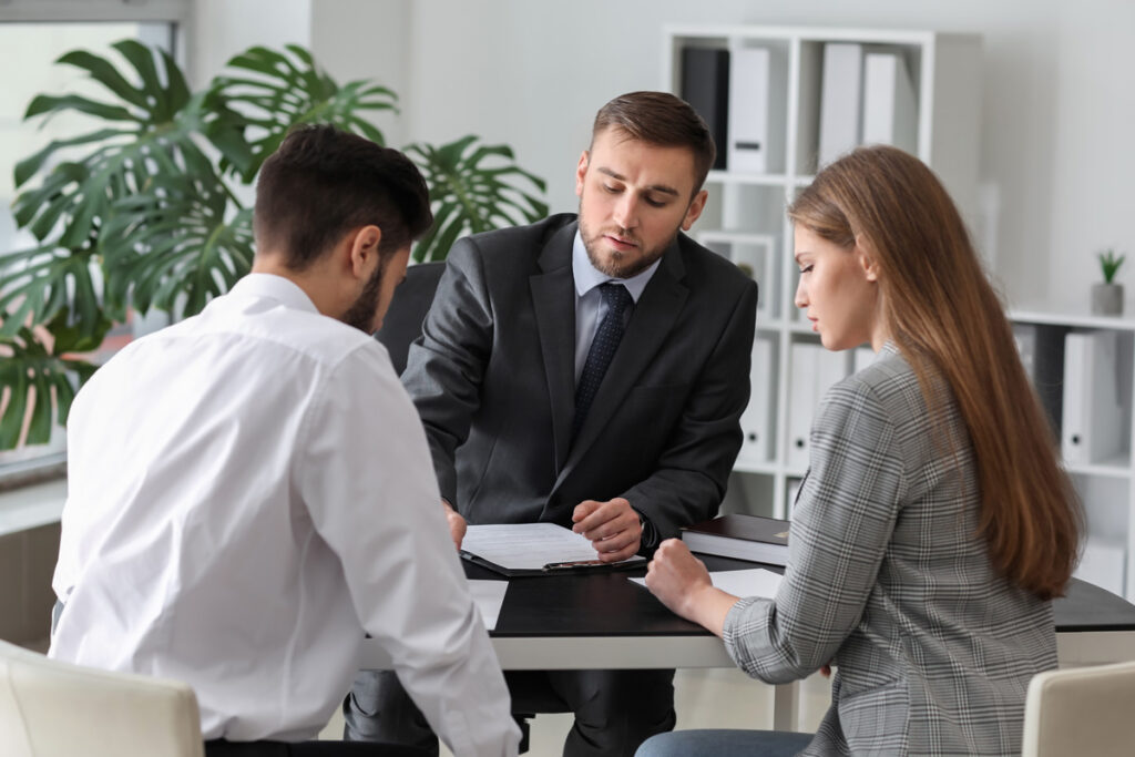 A divorce attorney filing paperwork with a divorced couple in El Paso.